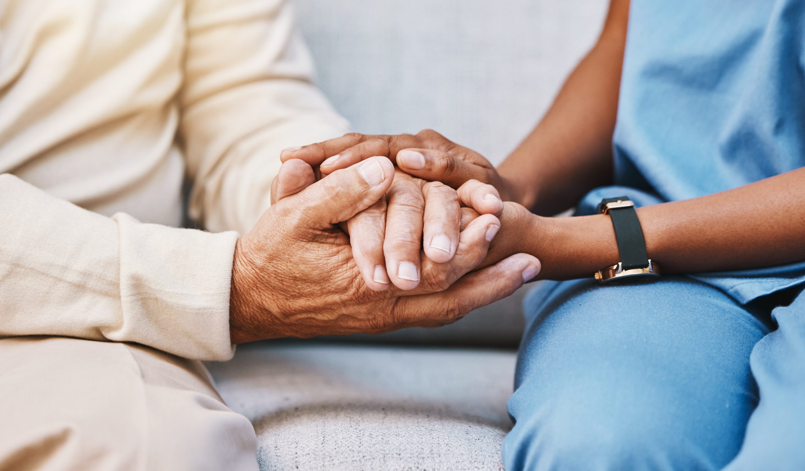 Nurse holding a patient's hand